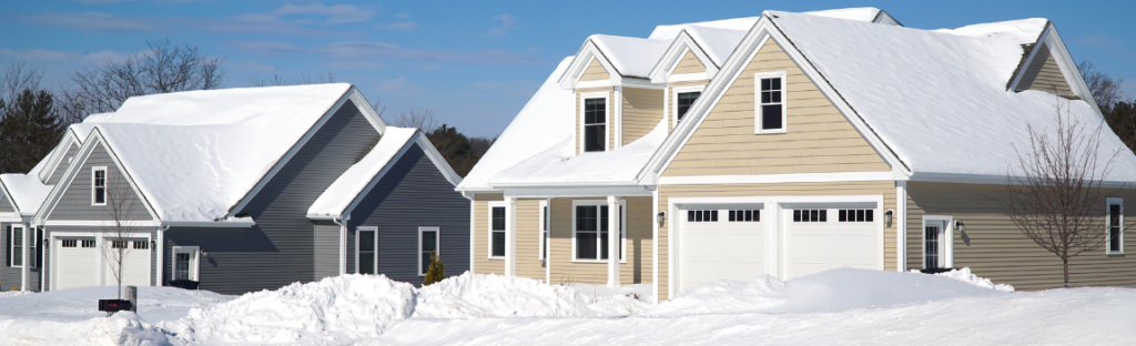 two homes covered in snow