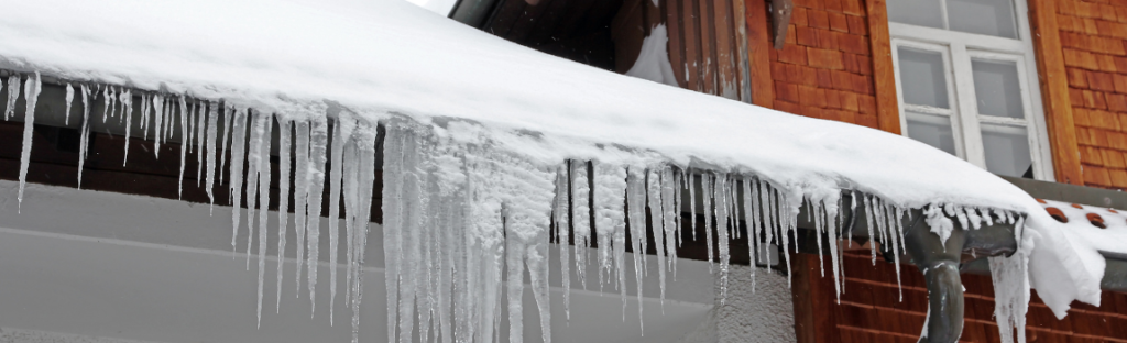 ice dams and large icicles and snow on roof