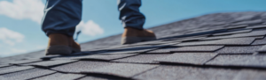 roofer walking on shingle roof
