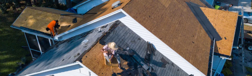 two men replacing roof
